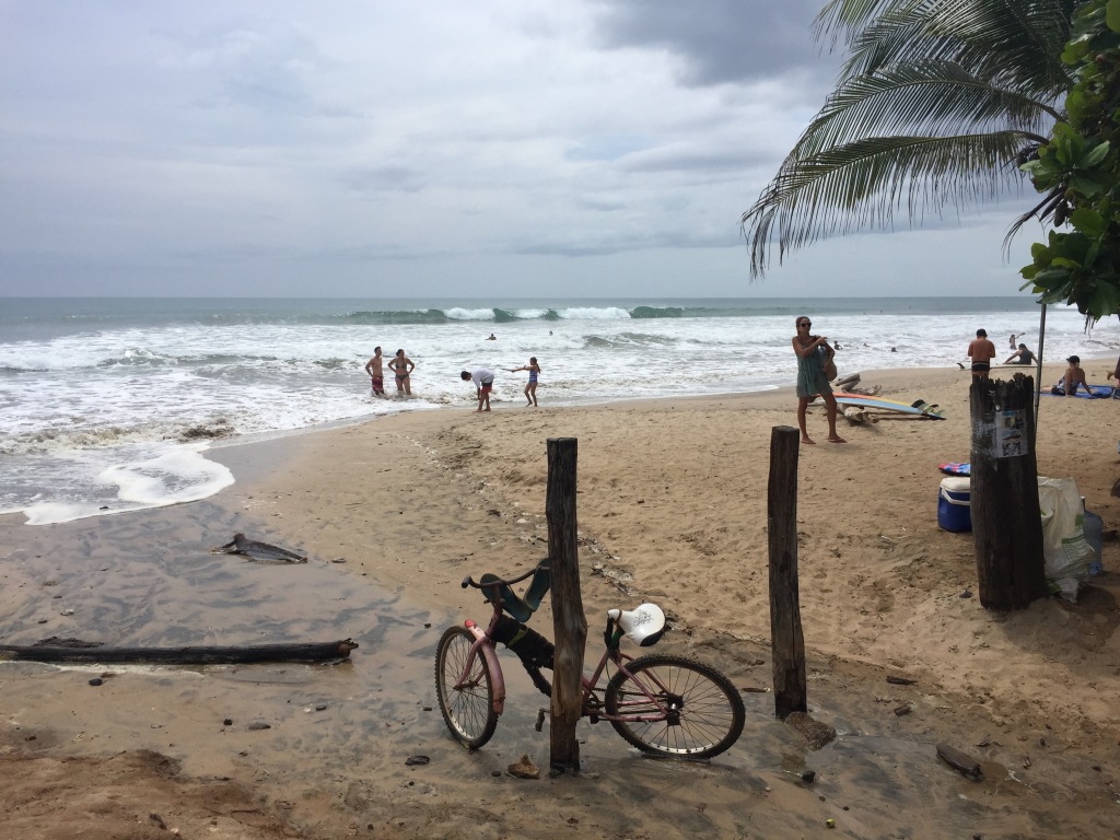 A bike rests on a wood pole at PLaya Avellanas in Costa Rica.