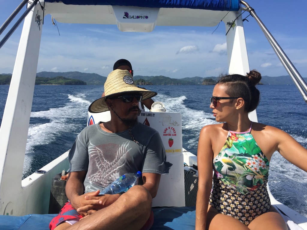 A Costa Rican couple rides a boat to go surfing.