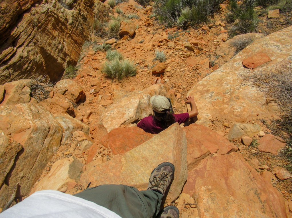 Madison climbs down a ledge on the trail to Mt. Kinesava.